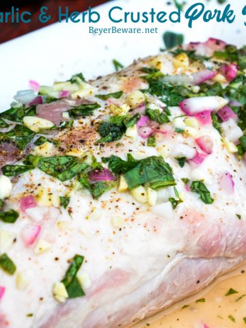 Garlic and Herb Crusted Grilled Pork Loin uses fresh herbs, garlic, and onions with simple wine, lemon juice, and oil marinade then grilled to juicy pork loin perfection.