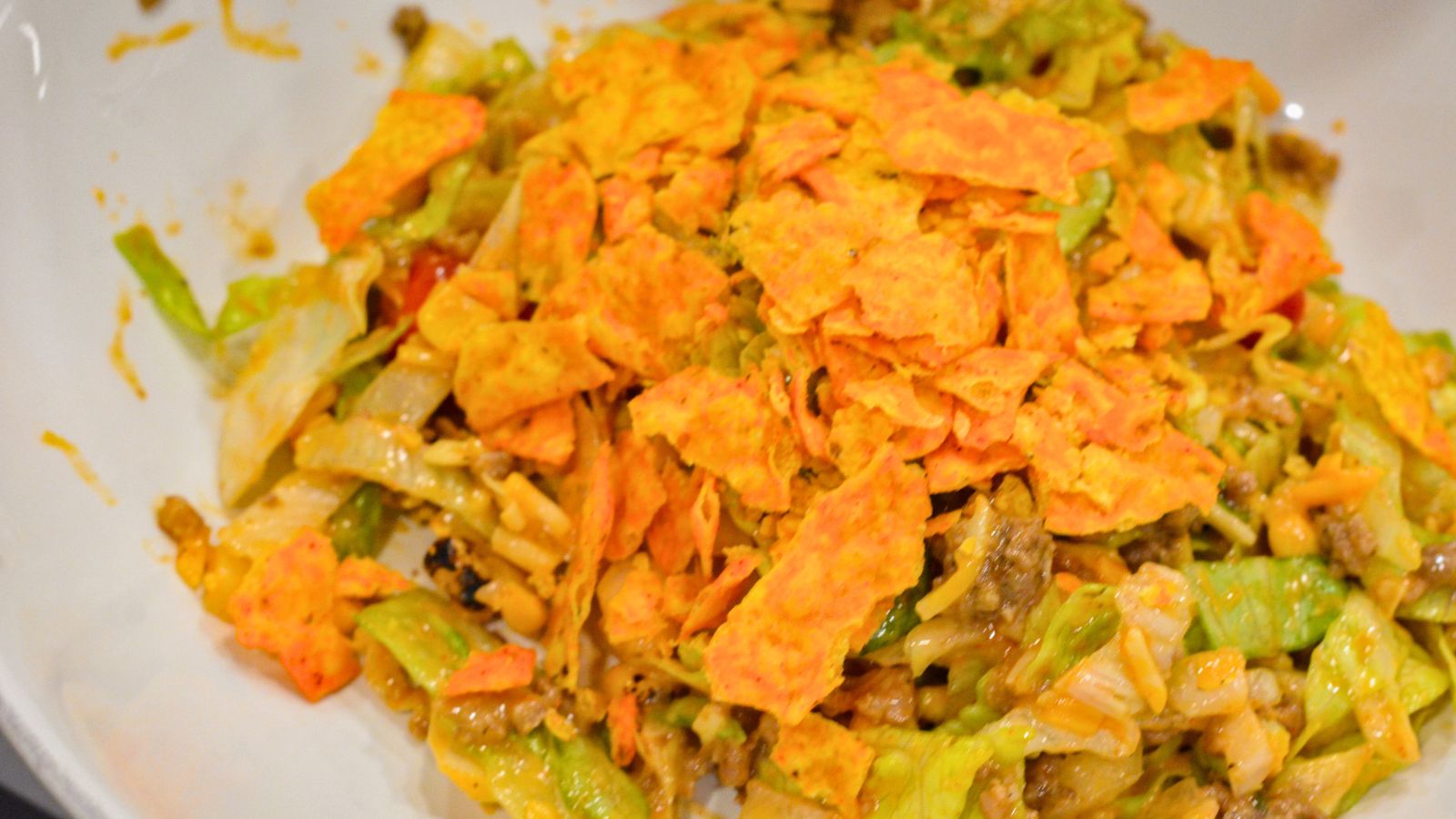 Make the best taco salad with seasoned ground beef, ranch and taco seasoning, and a delicious mix of ranch and Western dressing. This easy taco salad recipe is perfect for quick dinners and potlucks!