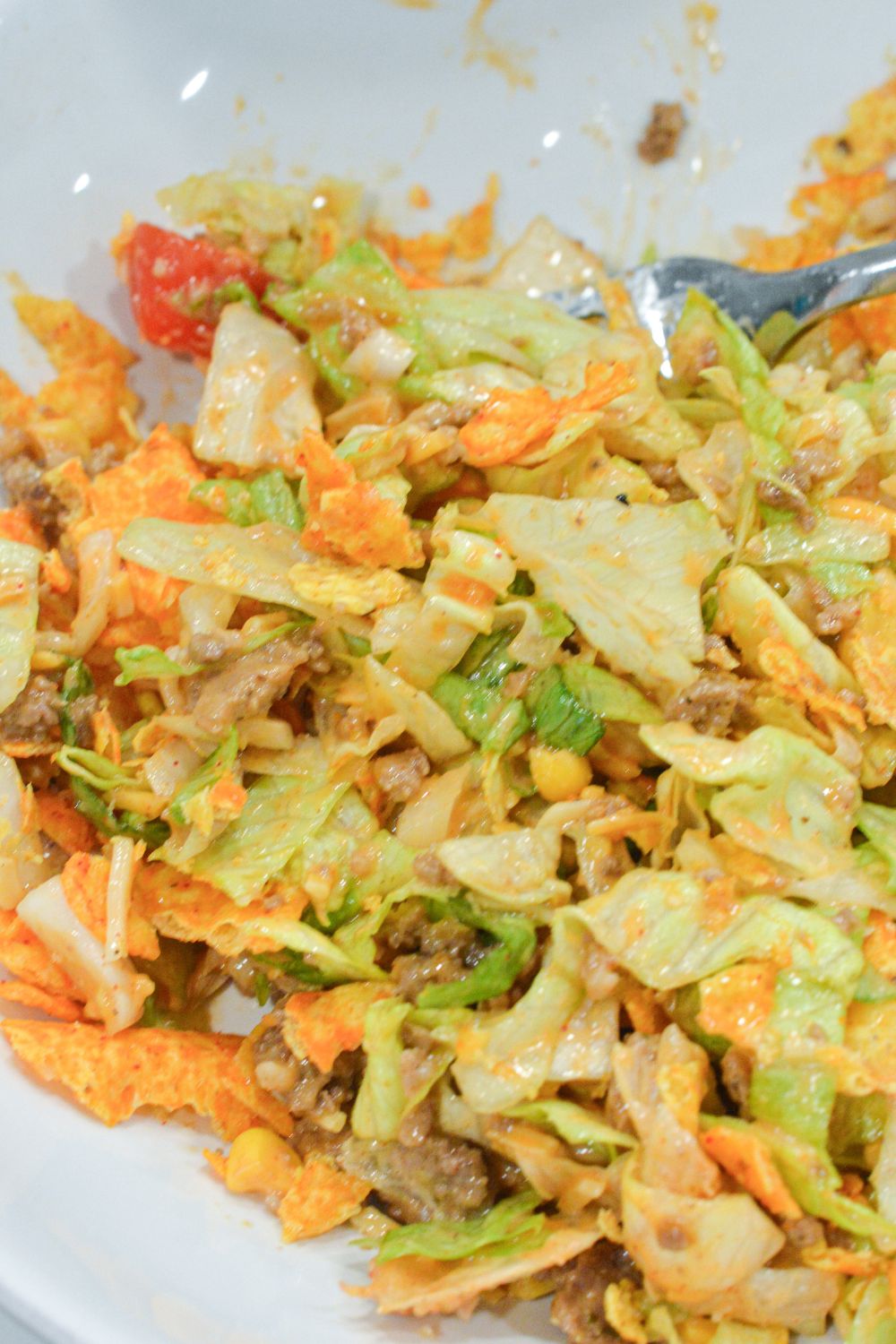 Make the best taco salad with seasoned ground beef, ranch and taco seasoning, and a delicious mix of ranch and Western dressing. This easy taco salad recipe is perfect for quick dinners and potlucks!