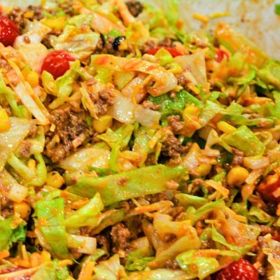 Add the ground beef taco meat to the salad and stir to combine the taco salad just before serving.