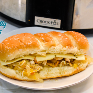 Crock pot chicken philly sandwiches are an easy pulled chicken sandwiches made with onion, peppers, chicken, steak seasoning, and butter.