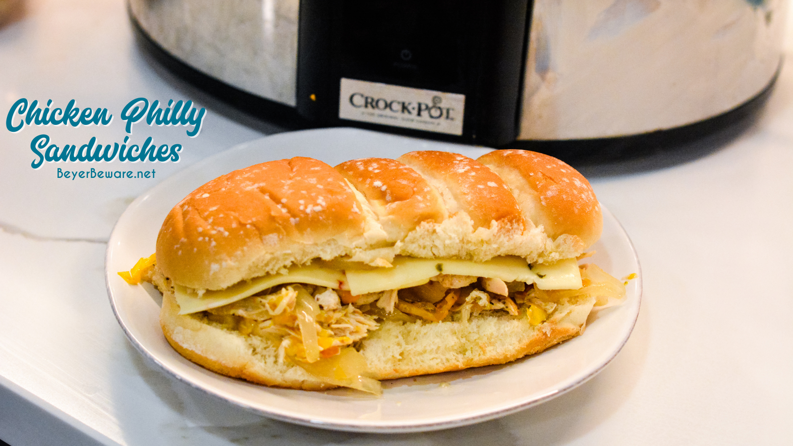 Crock pot chicken philly sandwiches are an easy pulled chicken sandwiches made with onion, peppers, chicken, steak seasoning, and butter.