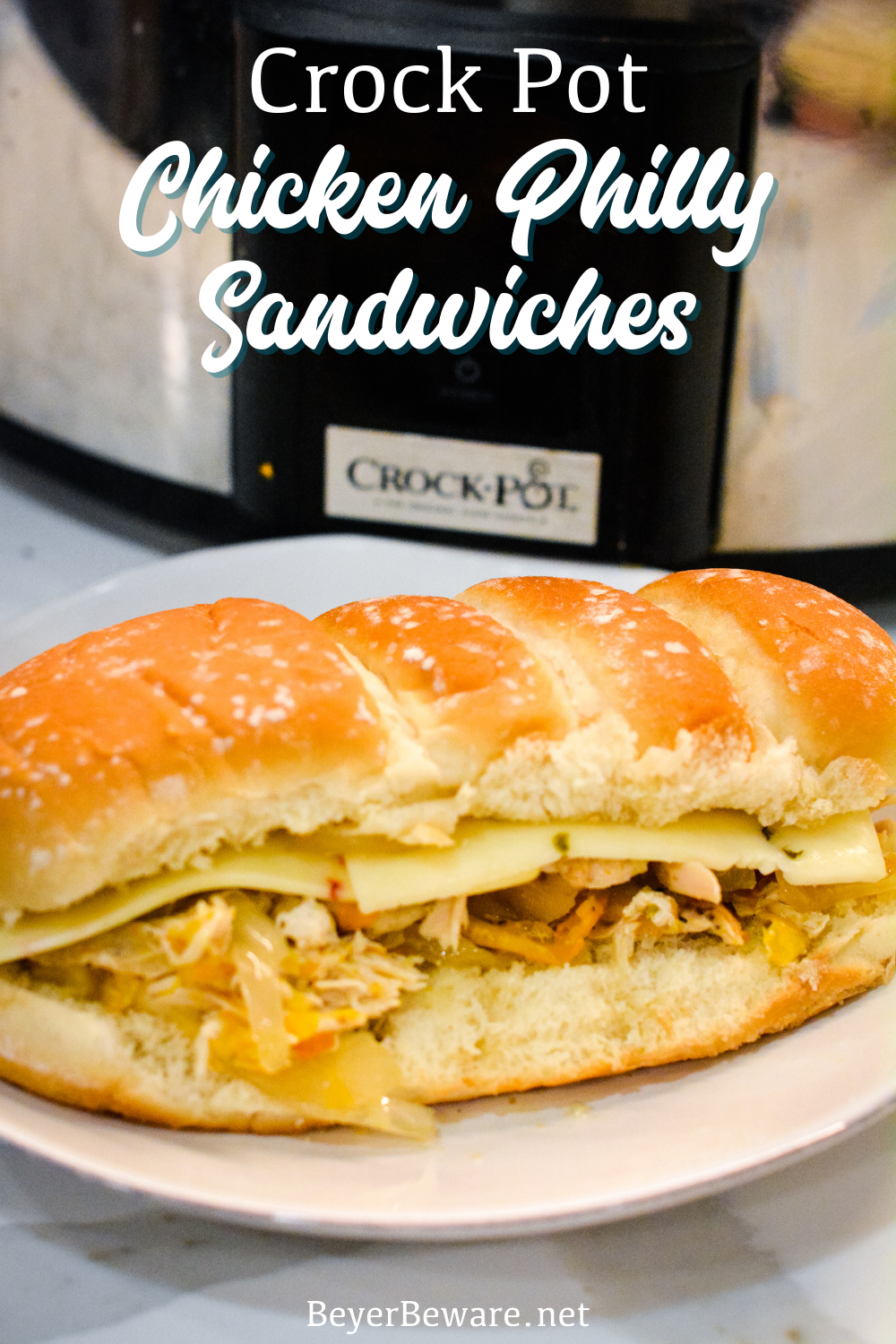 Crock pot chicken philly sandwiches are an easy pulled chicken sandwiches made with onion, peppers, chicken, steak seasoning, and butter.