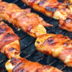 Grilled bacon-wrapped BBQ chicken recipe is lightly seasoned chicken tenderloins that are then wrapped in bacon and then coated in a doctored up barbeque sauce before quickly grilling to perfection.