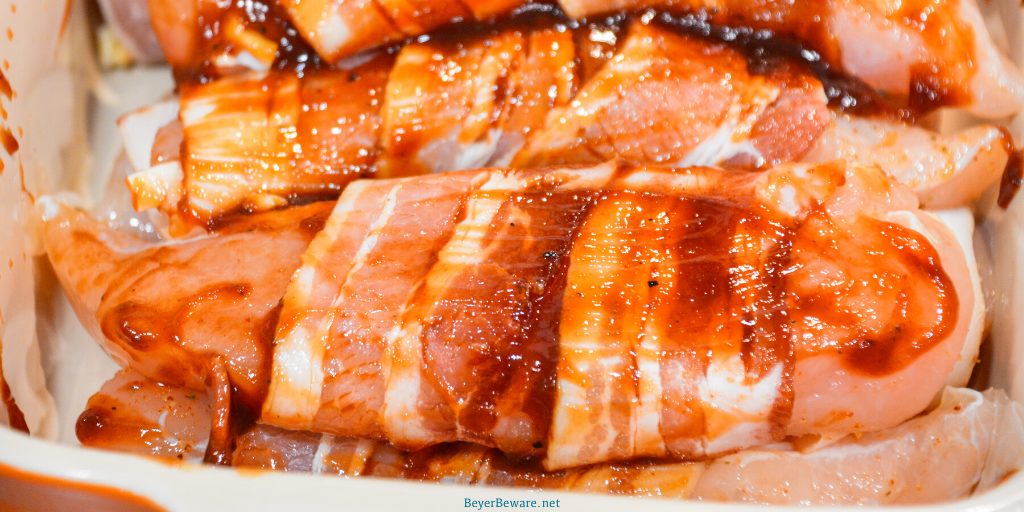 Grilled bacon-wrapped BBQ chicken recipe is lightly seasoned chicken tenderloins that are then wrapped in bacon and then coated in a doctored up barbeque sauce before quickly grilling to perfection.