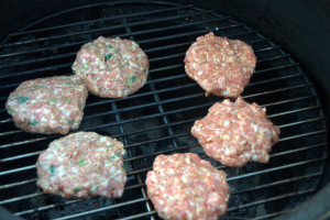 This grilled pineapple pork burger recipe mixes Asian seasonings with ground pork then topped with a slice of grilled pineapple and a teriyaki sauce.