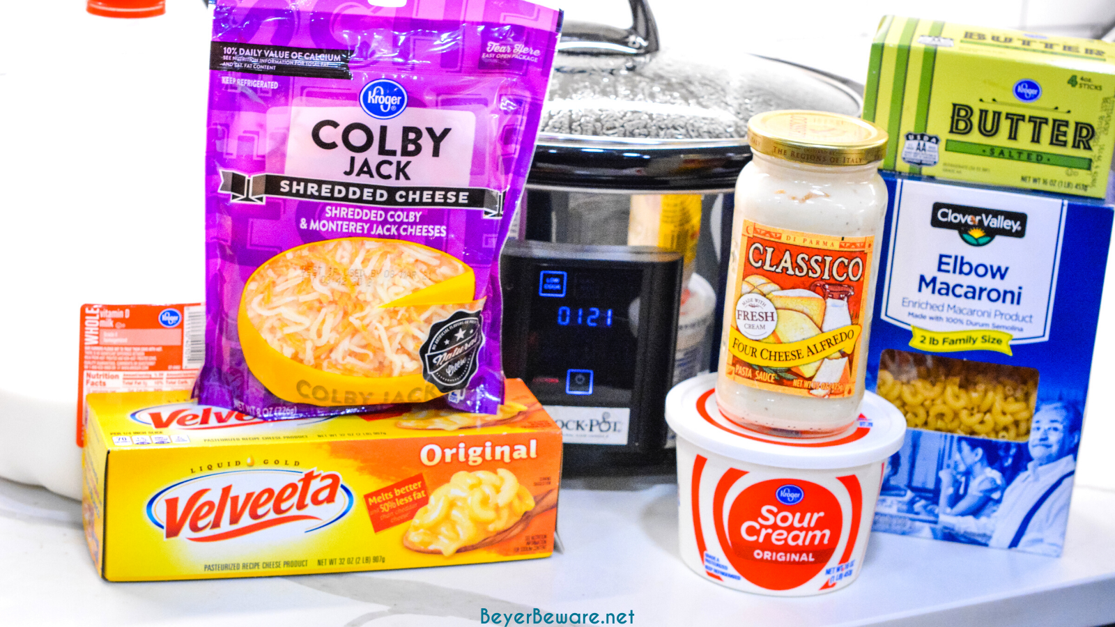 Crock pot mac and cheese recipe is made with alfredo sauce, sour cream, velveeta for ultimate slow cooker mac n cheese.