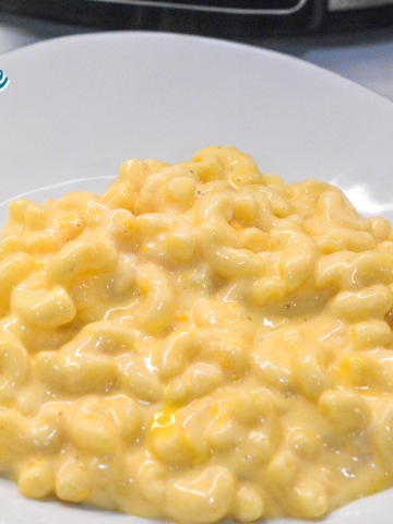 Crock pot mac and cheese recipe is made with alfredo sauce, sour cream, velveeta for ultimate slow cooker mac n cheese.