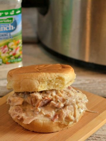 A simple crock pot creamy chicken bacon ranch recipe that is the perfect shredded chicken sandwich.