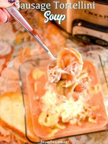 Crock pot sausage tortellini soup is a creamy tomato soup made with cheese tortellini and Italian sausage in two to three hours in the crockpot for a hearty and filling soup recipe.