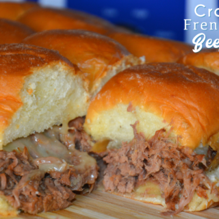 Crock Pot French onion shredded beef sliders recipe is a shredded French onion beef roast made with canned French onion soup, onions, butter and beef broth used to make cheesy sliders on Hawaiian rolls.
