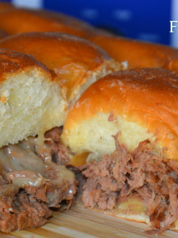 Crock Pot French onion shredded beef sliders recipe is a shredded French onion beef roast made with canned French onion soup, onions, butter and beef broth used to make cheesy sliders on Hawaiian rolls.