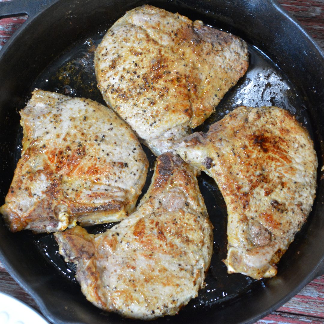 Pan-Fried pork chops recipe has no flour, no marinading, no waiting, just juicy, flavorful pork chops cooked in a buttered cast iron skillet.