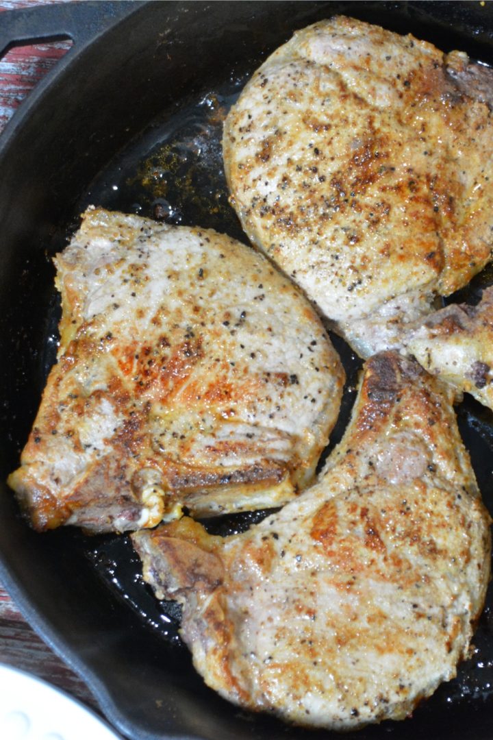 Flourless Pan-Fried pork chops recipe has no flour, no marinading, no waiting, just juicy, flavorful pork chops cooked in a buttered cast iron skillet.