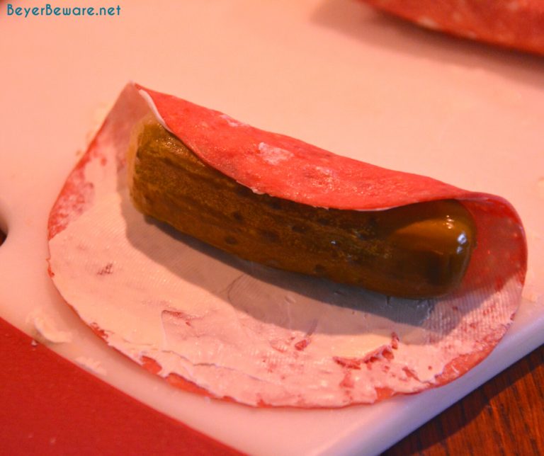 Continue wrapping the pickle with one or two more pieces of meat and
