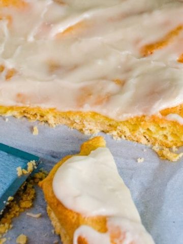 Almond Danish Puff Pastry has a flaky thin crust with a soft eggy bread layer that is drenched in almond flavoring and then covered with a light almond icing.