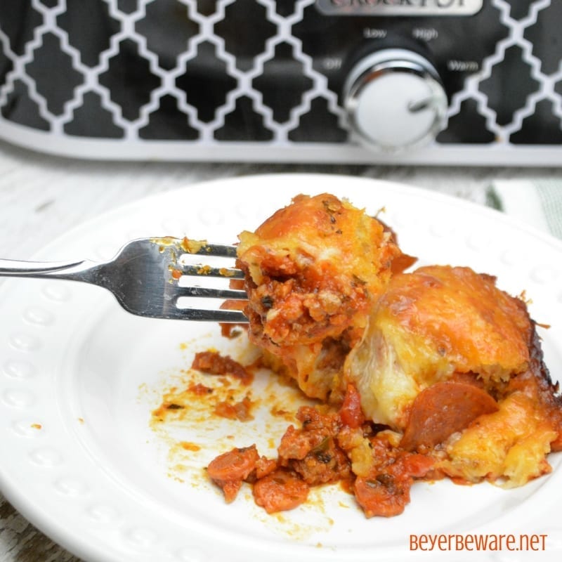 Crock pot bubble up pizza casserole is an easy bubble pizza casserole made with grands biscuits, spaghetti sauce, and your favorite pizza toppings. 