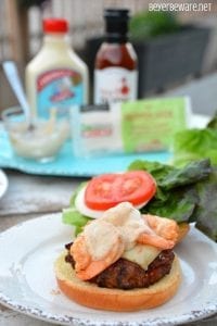 The Cajun pork burgers topped with shrimp and then drenched in a Cajun aioli combine ground pork, chorizo, with a Cajun seasoned horseradish mayonnaise for a perfect surf and turf burger recipe.