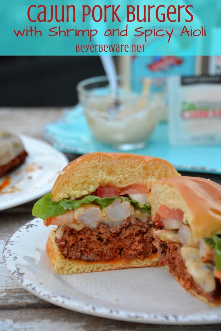 The Cajun pork burgers topped with shrimp and then drenched in a Cajun aioli combine ground pork, chorizo, with a Cajun seasoned horseradish mayonnaise for a perfect surf and turf burger recipe.