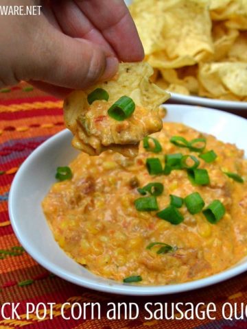 This crock pot corn and sausage queso dip is spicy from the addition of chorizo with a hint of sweet from the corn sure to make it your new favorite cheese queso dip recipe.