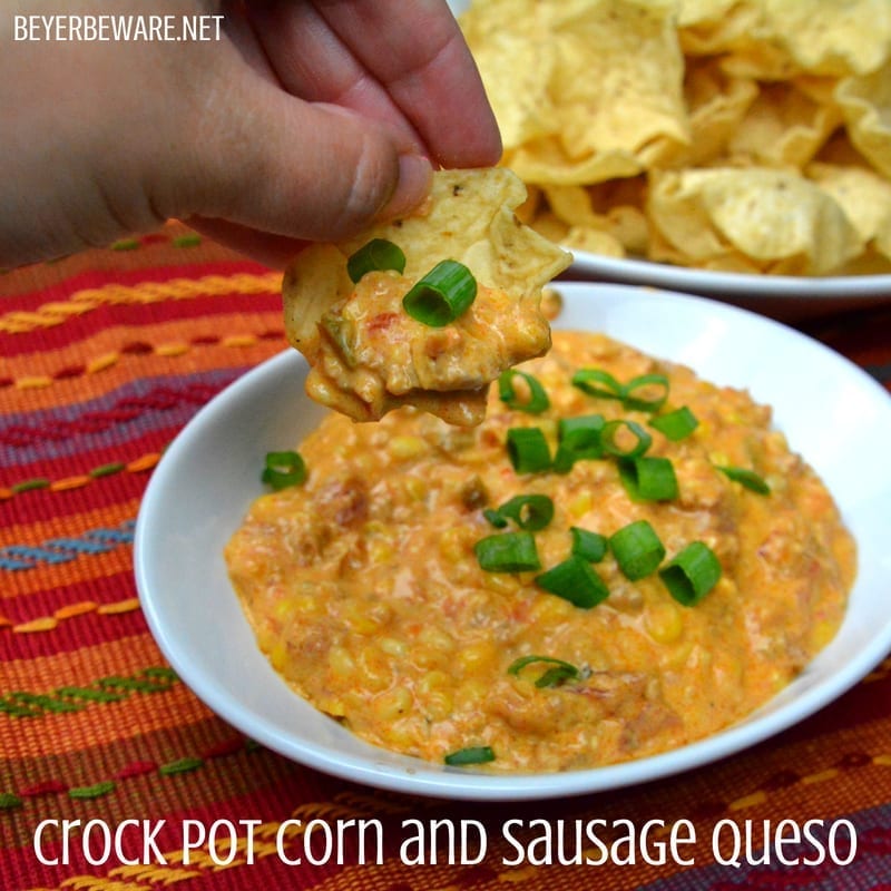 This crock pot corn and sausage queso dip is spicy from the chorizo with a hint of sweet from the corn and will be a new favorite cheese queso dip recipe.