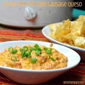 This crock pot corn and sausage queso dip is spicy from the addition of chorizo with a hint of sweet from the corn sure to make it your new favorite cheese queso dip recipe.