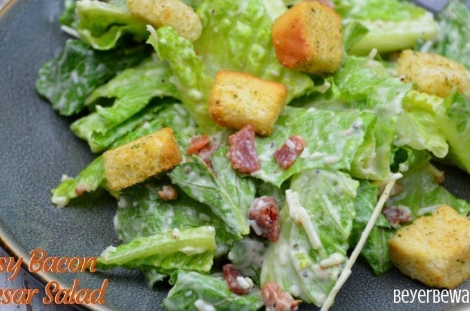 Easy bacon caesar salad is a simple combination of the basic Caesar salad ingredients of romaine lettuce, parmesan cheese, caesar dressing and croutons and taken up a notch with the addition of bacon.