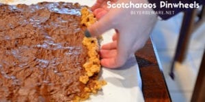 These scotcharoos pinwheels combine the crispy rice cereal, peanut butter, sugar, and corn syrup for the base and then topped and rolled with melted butterscotch and chocolate. #PeanutButter #Chocolate #Nobake #DessertRecipes #BarRecipes