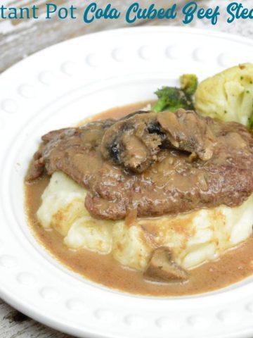 Instant Pot Coca-Cola Cubed Beef Steaks is a simple recipe made quickly with the dump of cubed steaks, a Coke, onion soup mix and cream of mushroom soup in the Instant Pot.