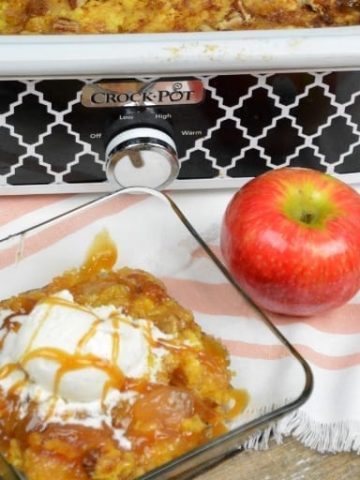 Crock Pot Apple Pie Dump Cake recipe is just a few simple ingredients of apple pie filling, cake mix, butter and pecans and in the crock pot for a couple hours. #CrockPot #Apple #DumpCake