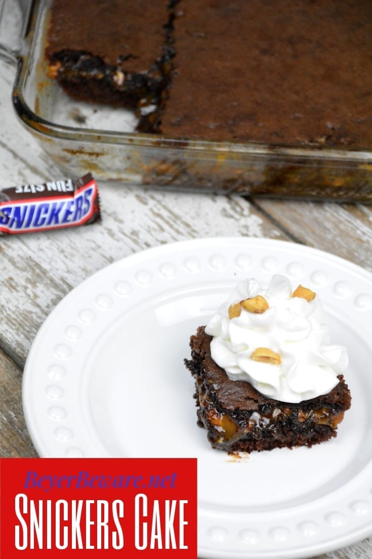 Snickers cake recipe takes a chocolate cake mix up a notch by filling it with caramel, peanuts and chocolate chips making for the cake version of a favorite candy bar. #CakeMix #Snickers #Caramel #Chocolate