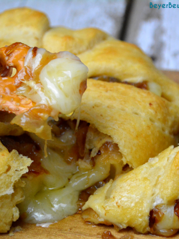 Caramelized onion baked brie crescent round is a simple brie en croute recipe made with caramelized onions and brie for a baked brie recipe.