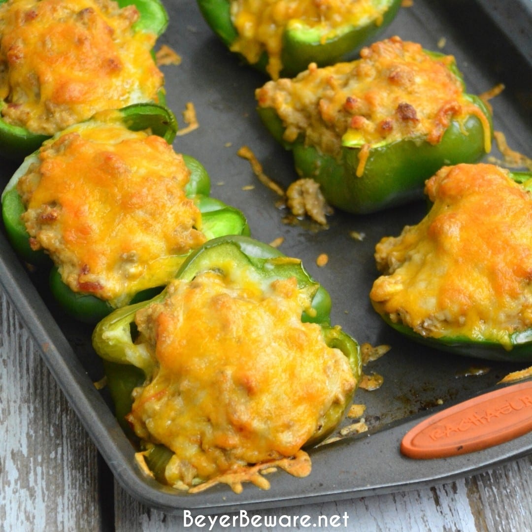 Low-Carb Taco Stuffed Peppers are a 9 net carb low carb stuffed pepper recipe with a queso sausage filling that is full of your favorite Mexican flavors and baked to form a cheesy crust over the peppers and sausage filling for a keto taco like dinner.