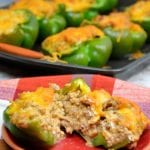 Low-Carb Taco Stuffed Peppers are a 9 net carb low carb stuffed pepper recipe with a queso sausage filling that is full of your favorite Mexican flavors and baked to form a cheesy crust over the peppers and sausage filling for a keto taco like dinner.