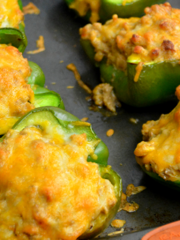 Low-Carb Taco Stuffed Peppers have a queso sausage filling that is full of your favorite Mexican flavors and baked to form a cheesy crust over the peppers and sausage filling. #Keto #Lowcarb #StuffedPeppers #Sausage #Queso #GlutenFree