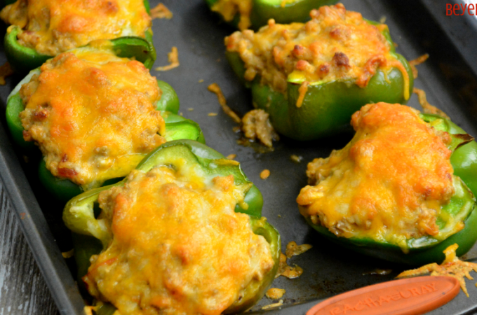 Low-Carb Taco Stuffed Peppers have a queso sausage filling that is full of your favorite Mexican flavors and baked to form a cheesy crust over the peppers and sausage filling. #Keto #Lowcarb #StuffedPeppers #Sausage #Queso #GlutenFree