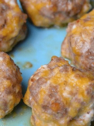 Low-Carb sausage balls use ground pork, cream cheese, parmesan and shredded cheeses to form the base for an oven baked pork meatball. #keto #lowcarb #meatballs #sausage