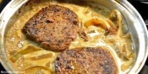Low Carb One-Pan Salisbury Steak is skillet cooked in butter with onions and mushrooms to set the base of creamy brown gravy to drench the steaks. #lowcarb #keto #Beef #GlutenFree #SalisburySteak #Mushrooms #Recipes