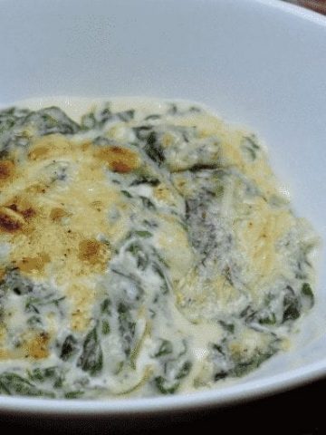 Keto Creamed Spinach is a simple gluten free creamed spinach recipe combining steamed spinach, butter, heavy whipping cream, and mozzarella and parmesan cheeses. #GlutenFree #LowCarb #Keto #SideDishes #Recipes #Keto #Spinach #Cheese