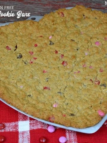 Gluten-Free Monster Cookie bars are a flourless cookie cake recipe combining peanut butter, oats, chocolate chips, and M & Ms to create a chewy chocolate cookie treat.