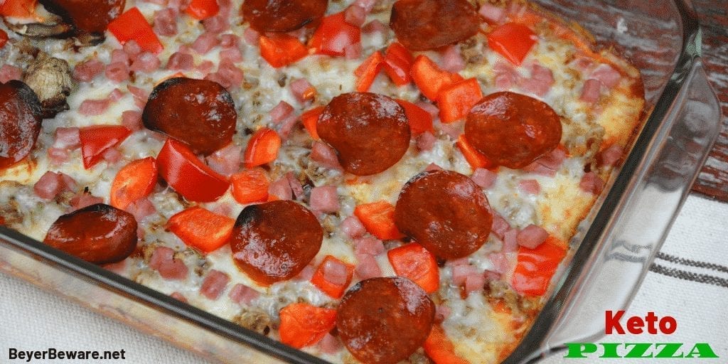Keto pizza made with a cream cheese crust and topped with a thin layer of tomato sauce, your favorite toppings, and cheese. #Keto #LowCarb #Pizza #KetoPizza #LowCarbCrust