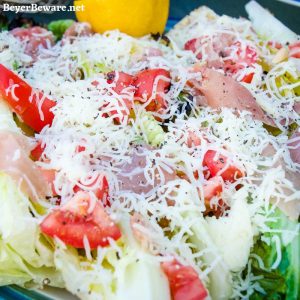 Grilled romaine salad topped with prosciutto, tomatoes, cheese and lemon juice & olive oil is the perfect BBQ side dish all summer long. #Salad #Grilling #lettuce #sidedish #Recipes