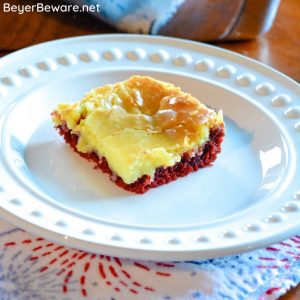 Red Velvet Ooey Gooey Butter Bars are a simple cake mix brownie baked with a cream cheese topping for your new favorite red velvet and cream cheese dessert. #RedVelvet #CakeMix #Dessert #Chocolate #Recipes