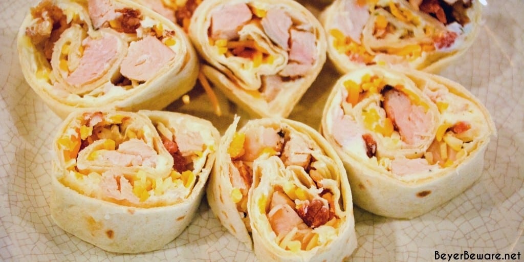 Chicken bacon ranch roll-ups are a quick tortilla wrap sandwich recipe sliced into pinwheels and filled with ranch cream cheese, chicken, bacon, and cheese.