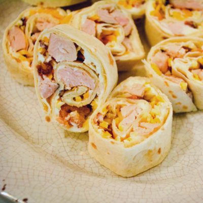 Chicken bacon ranch roll-ups are quick tortilla wrapped sandwich recipe filled with ranch flavored cream cheese, cubed chicken, bacon, and cheese and sliced into pinwheels.