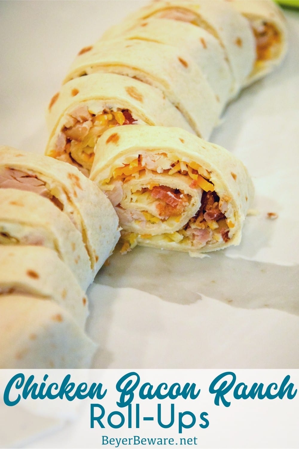 Chicken bacon ranch roll-ups are a quick tortilla wrap sandwich recipe sliced into pinwheels and filled with ranch cream cheese, chicken, bacon, and cheese.