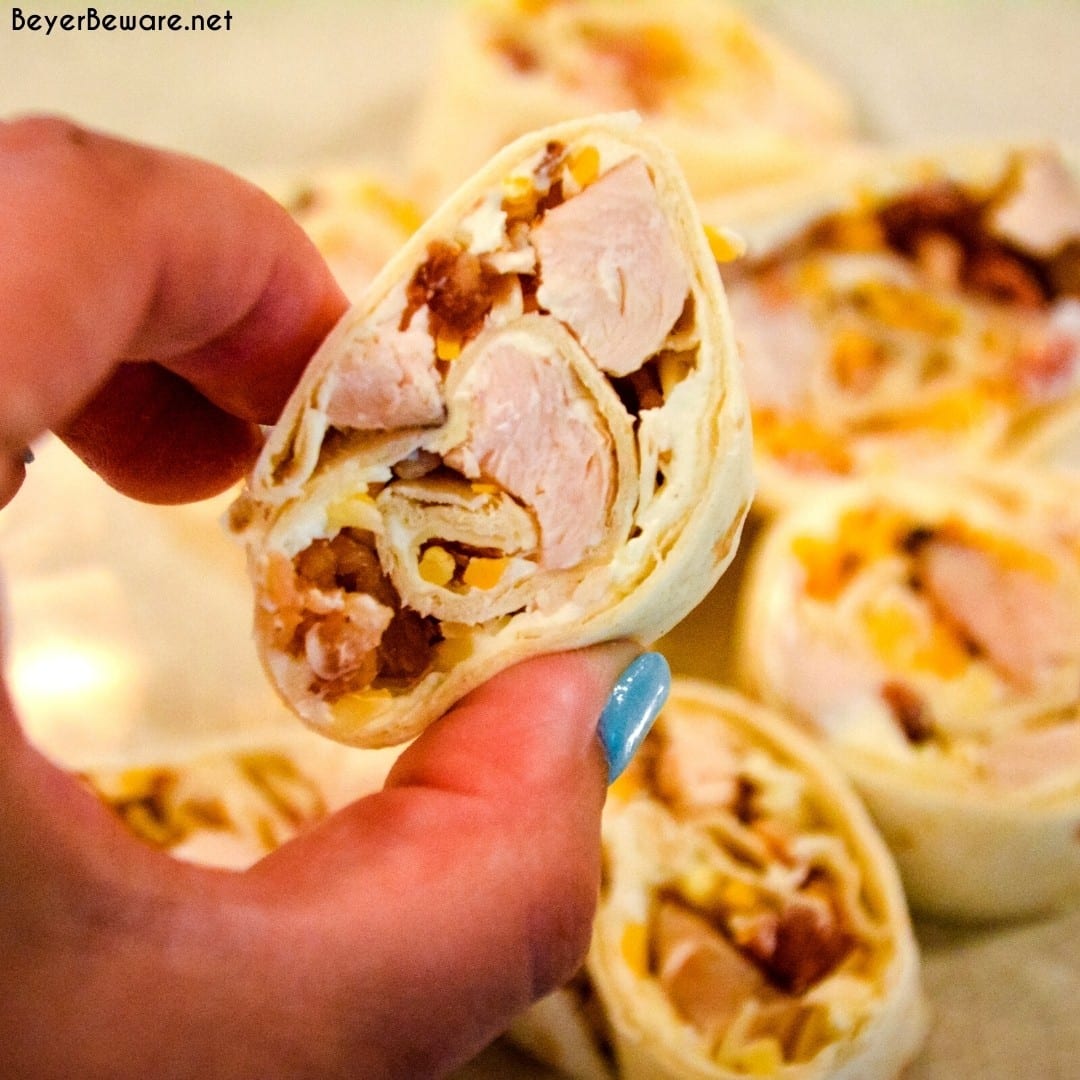 Chicken bacon ranch roll-ups are a quick tortilla wrap sandwich recipe sliced into pinwheels and filled with ranch cream cheese, chicken, bacon, and cheese.