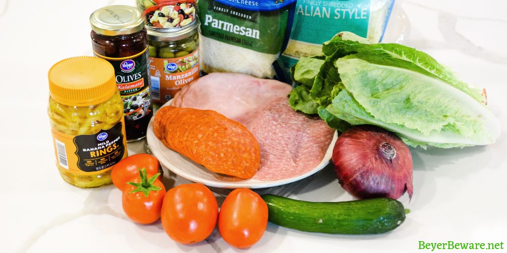 Italian antipasto salad is a hearty dinner salad with a romaine lettuce base and filled up with salami, pepperoni, tomatoes, cucumbers, onions, olives, banana peppers, and cheese dressed with a homemade Italian dressing.