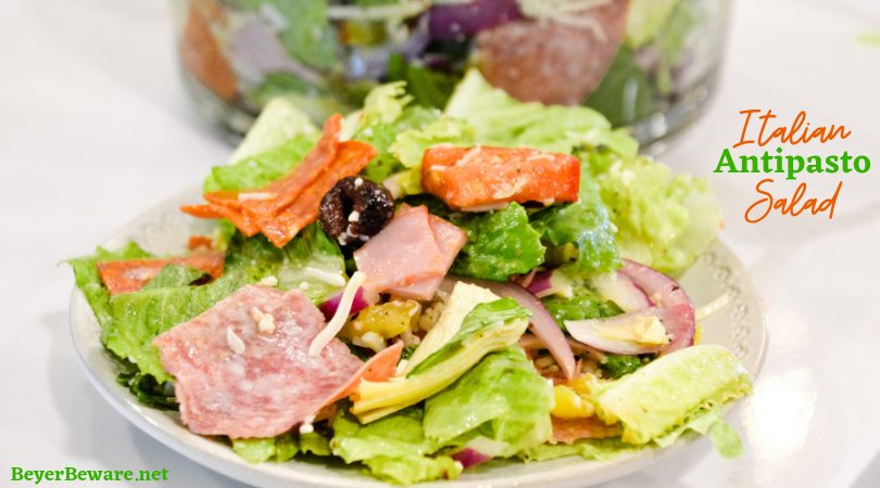 Italian antipasto salad is a hearty dinner salad with a romaine lettuce base and filled up with salami, pepperoni, tomatoes, cucumbers, onions, olives, banana peppers, and cheese dressed with a homemade Italian dressing. Make this like a grinder salad by adding mayonnaise to the salad dressing.