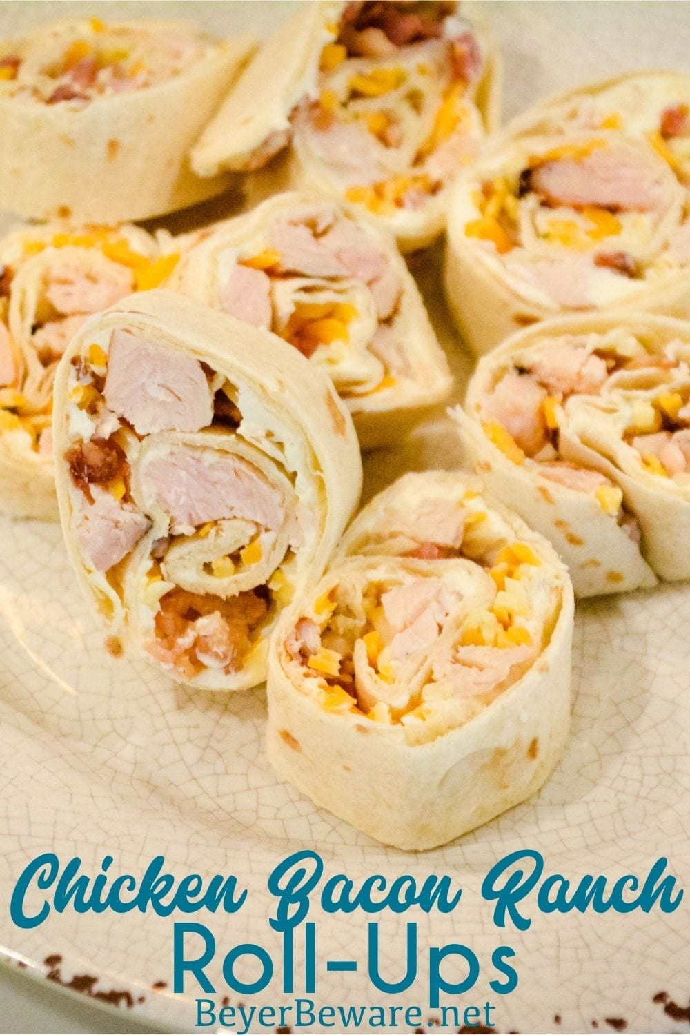 Chicken bacon ranch roll-ups are a quick tortilla wrap sandwich recipe sliced into pinwheels and filled with ranch cream cheese, chicken, bacon, and cheese.